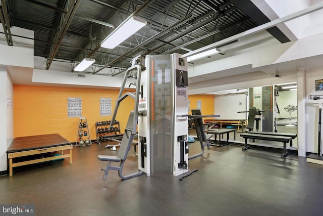 workout area featuring concrete block wall and visible vents