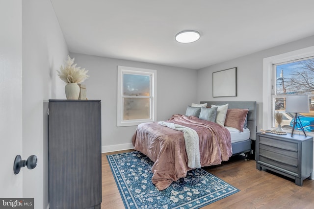 bedroom with baseboards and wood finished floors