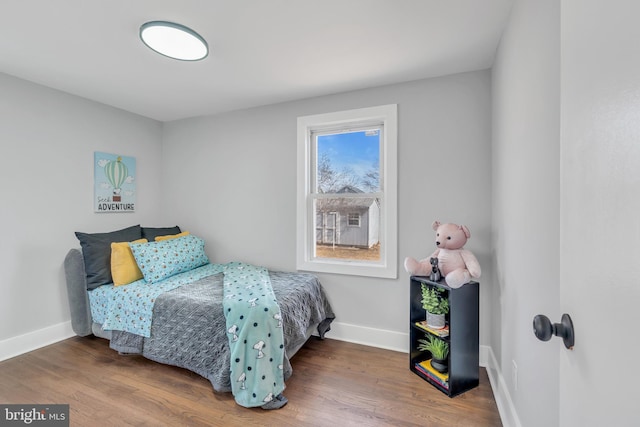 bedroom featuring baseboards and wood finished floors