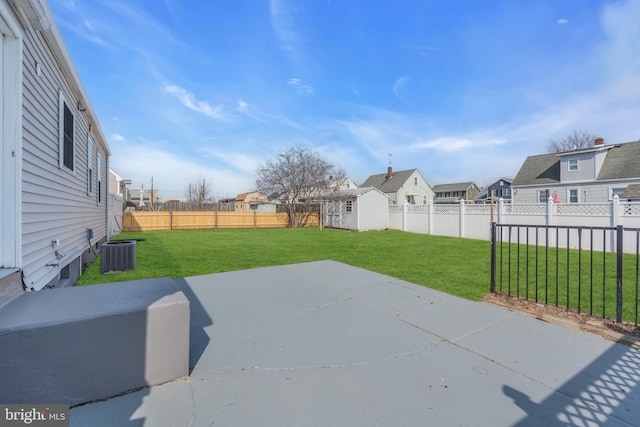 view of patio with a residential view, a fenced backyard, an outdoor structure, and central air condition unit