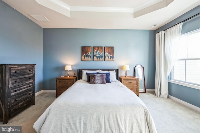 bedroom featuring a tray ceiling, baseboards, light carpet, and visible vents