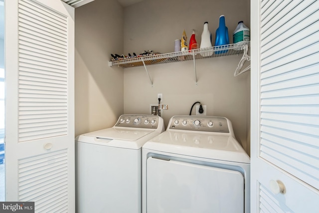 clothes washing area featuring laundry area and washing machine and clothes dryer