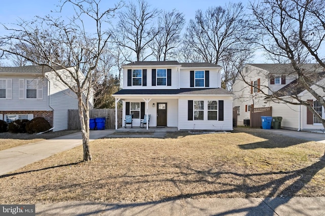 view of front of property with driveway, fence, a porch, central AC, and a front yard