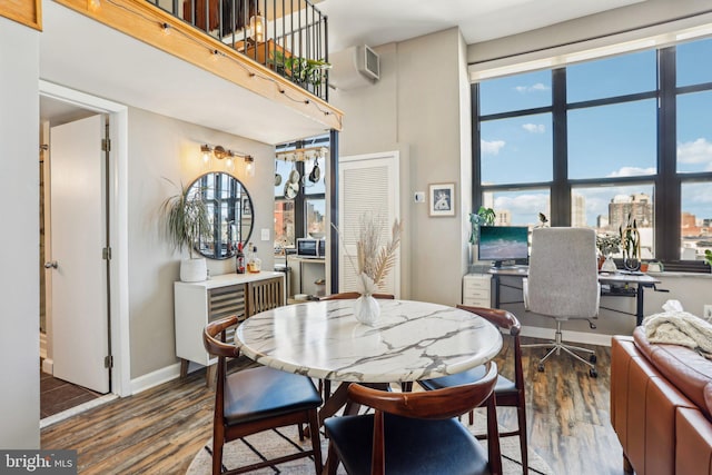 dining room featuring wood finished floors and baseboards