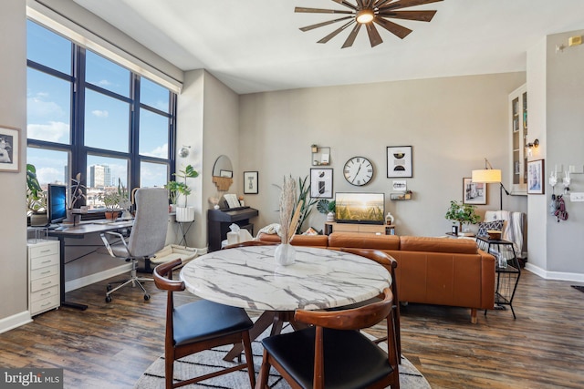 dining area with dark wood-type flooring and baseboards