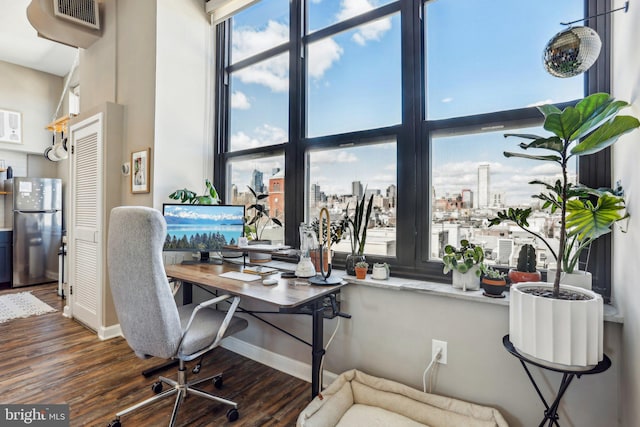 office featuring dark wood-style flooring, visible vents, and baseboards