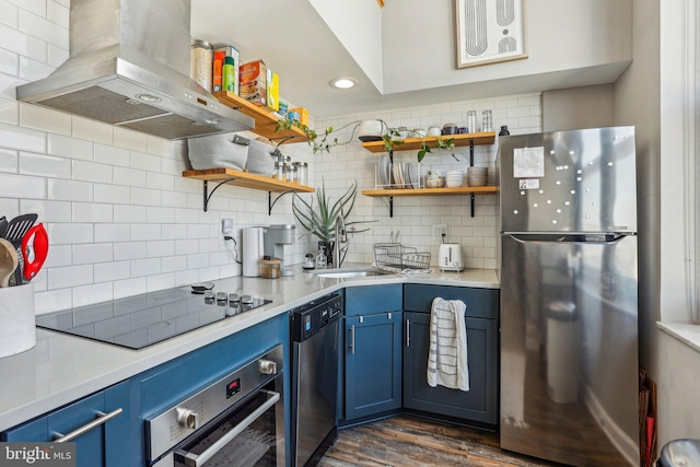 kitchen featuring blue cabinetry, tasteful backsplash, island exhaust hood, and stainless steel appliances