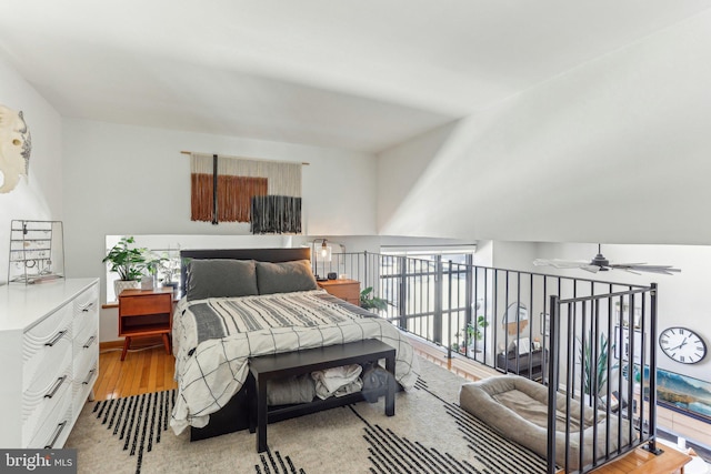 bedroom featuring access to exterior and wood finished floors