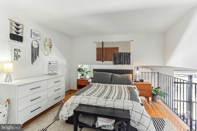 bedroom featuring baseboards and light wood finished floors