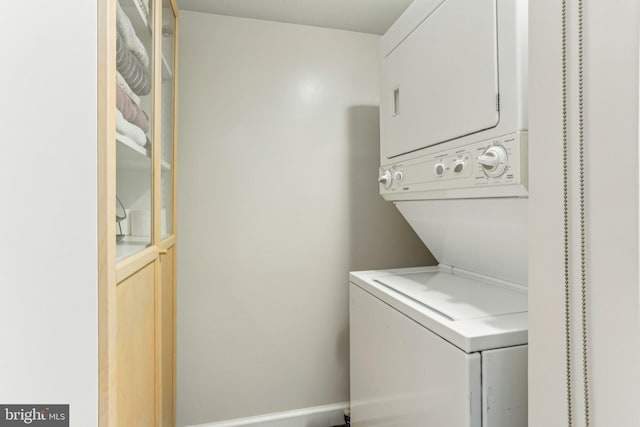 laundry area with stacked washer and clothes dryer and laundry area