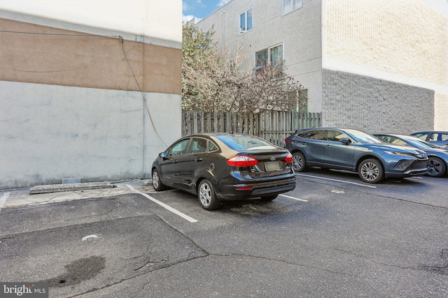 uncovered parking lot with fence