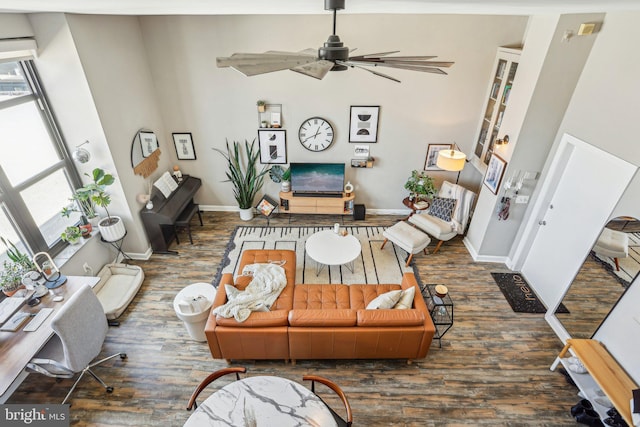 living room featuring ceiling fan, wood finished floors, and baseboards