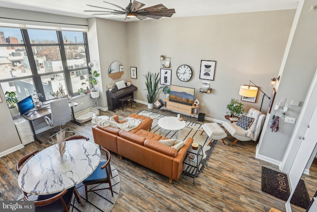 living area featuring ceiling fan, wood finished floors, and baseboards