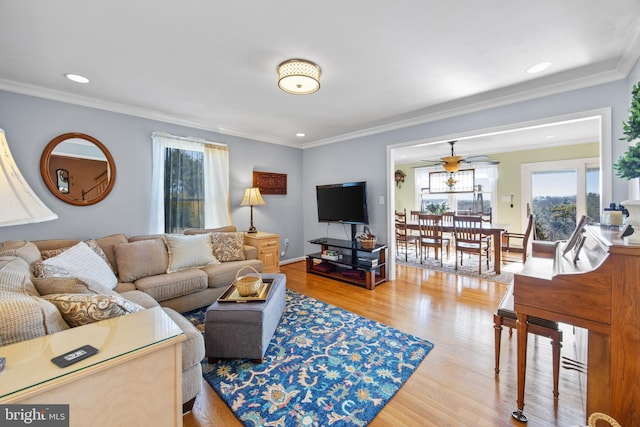 living area with a ceiling fan, crown molding, recessed lighting, and wood finished floors