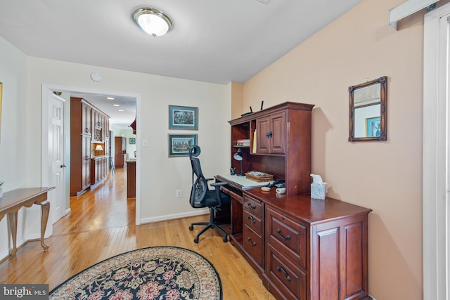 office area with light wood-style flooring and baseboards