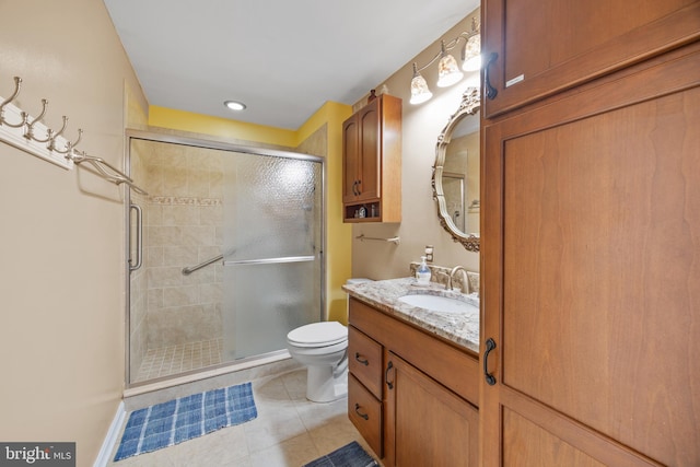 bathroom with tile patterned floors, toilet, a stall shower, and vanity