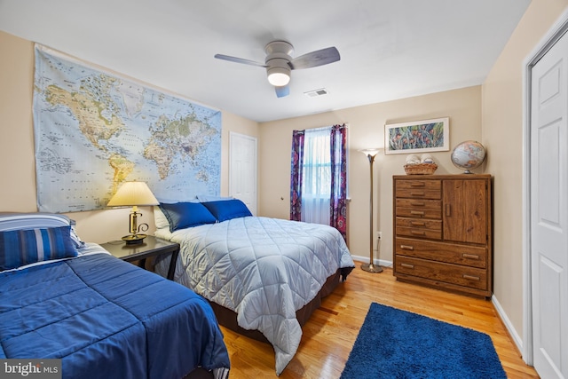 bedroom with baseboards, visible vents, and light wood-type flooring