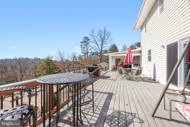 wooden deck with outdoor dining area