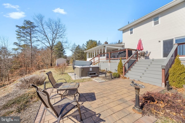 view of patio / terrace with a wooden deck and a hot tub