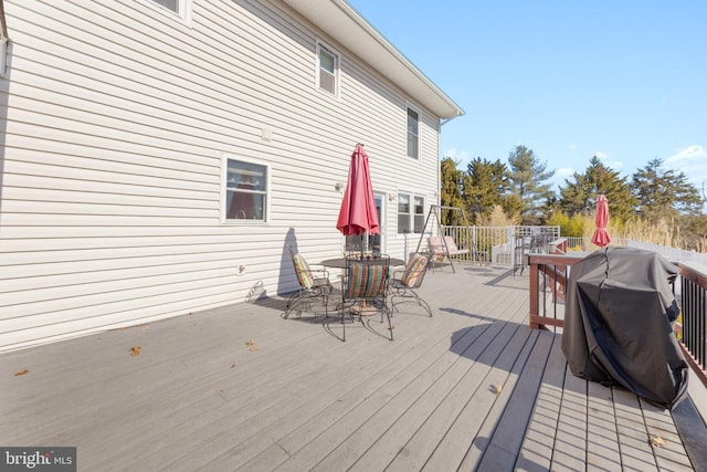 wooden terrace with outdoor dining area