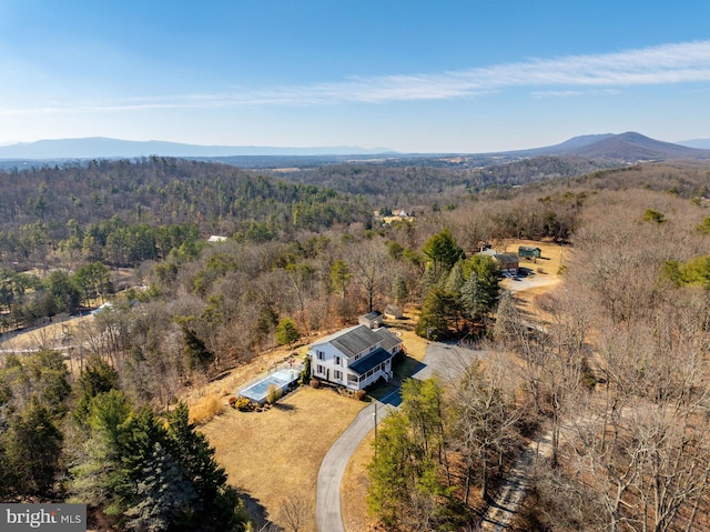 aerial view featuring a view of trees and a mountain view