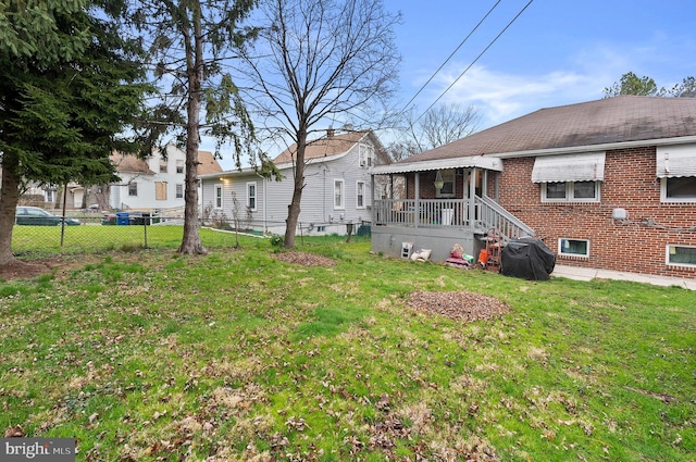 4103 Parkwood Ave, Baltimore, MD 21206 - rear view of house featuring a yard, fence, and brick siding