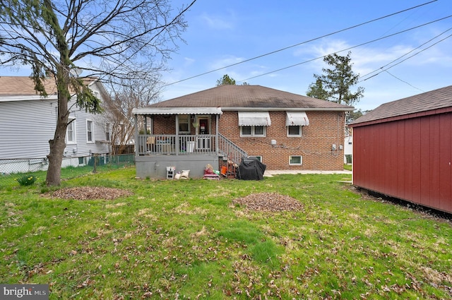 4103 Parkwood Ave, Baltimore, MD 21206 - back of property featuring a lawn, fence, and brick siding
