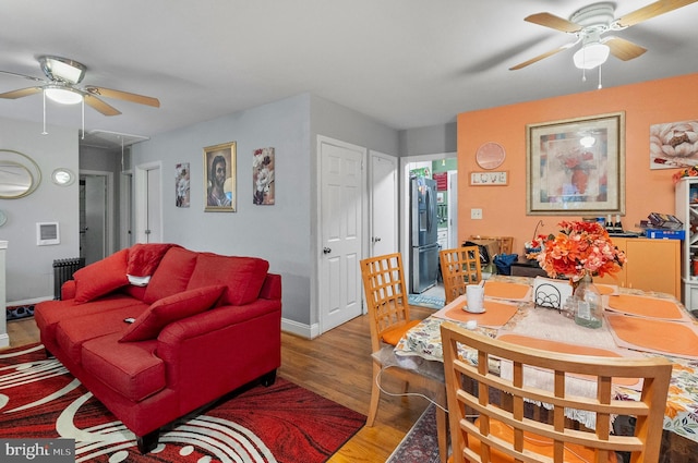 4103 Parkwood Ave, Baltimore, MD 21206 - living room featuring radiator, wood finished floors, attic access, and a ceiling fan