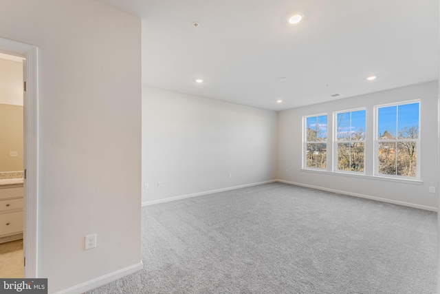 carpeted spare room with baseboards and recessed lighting