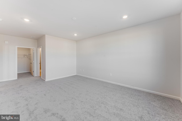 unfurnished room featuring carpet floors, baseboards, and recessed lighting