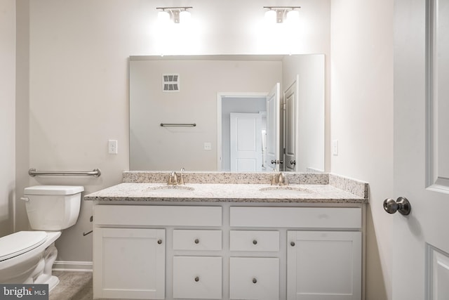 full bathroom featuring visible vents, a sink, toilet, and double vanity