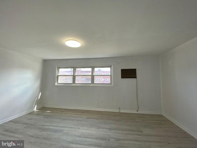 empty room featuring baseboards and wood finished floors