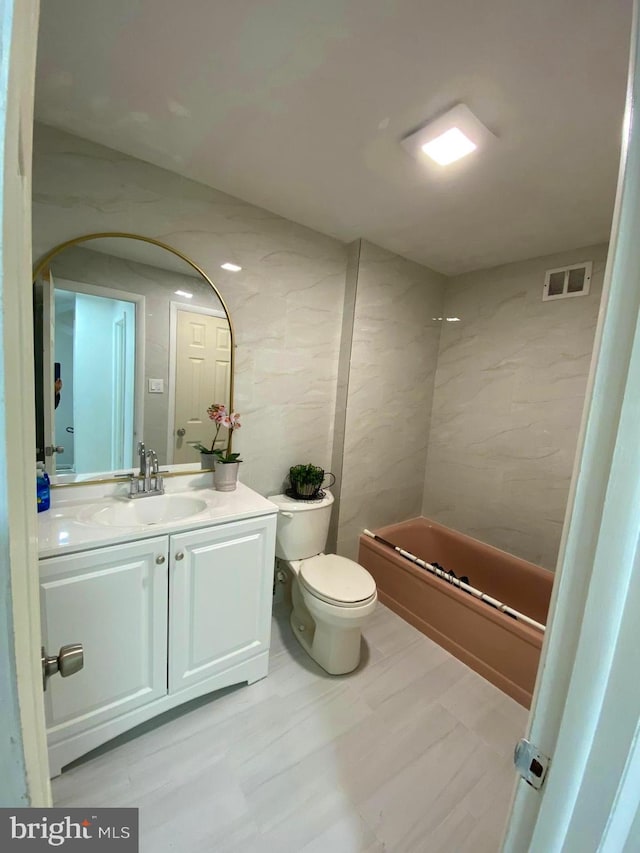 bathroom with washtub / shower combination, visible vents, vanity, and toilet