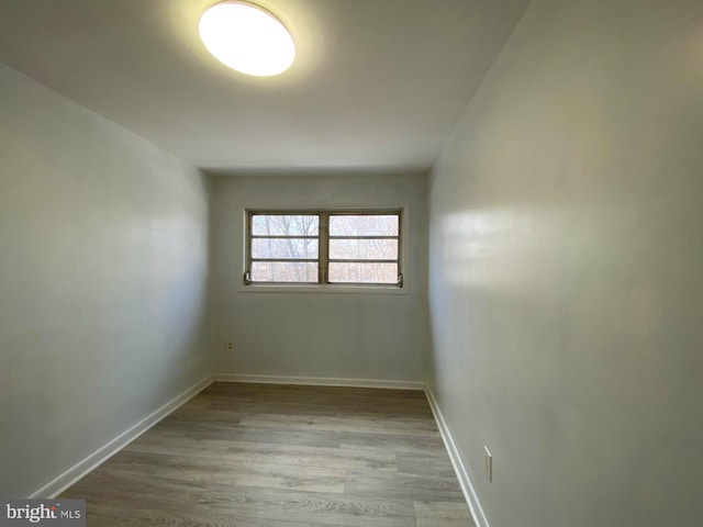 empty room with wood finished floors and baseboards