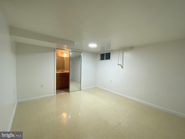 unfurnished bedroom featuring ensuite bath, baseboards, a sink, and recessed lighting