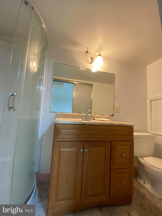 full bath with toilet, a stall shower, marble finish floor, and vanity