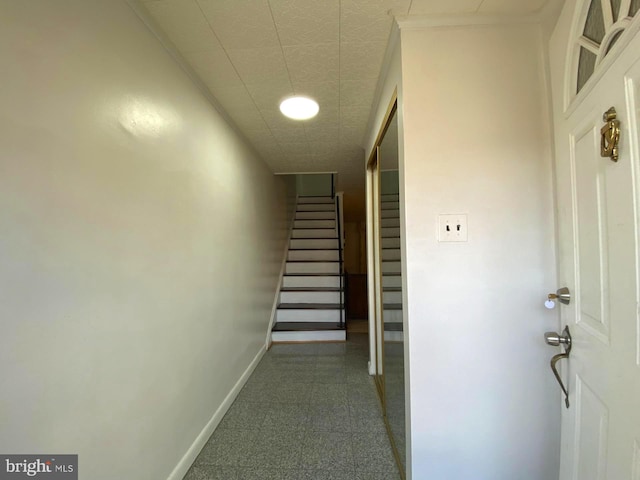 hallway with stairs and baseboards