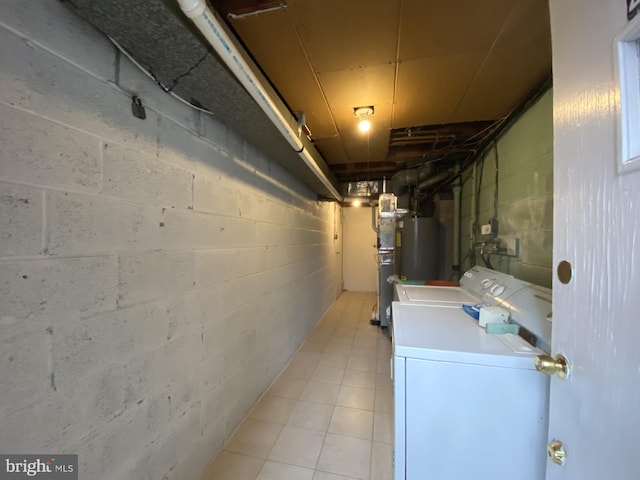 unfinished basement with washing machine and dryer and light tile patterned floors