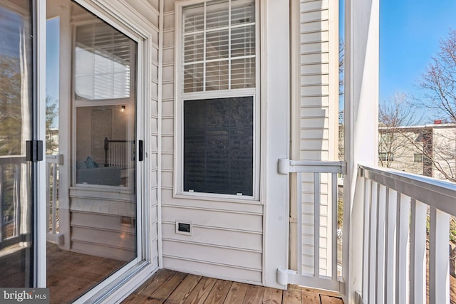 view of exterior entry with a balcony