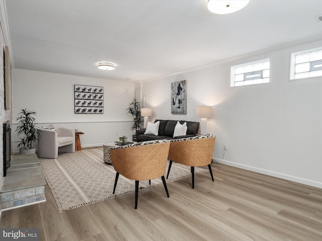 office featuring a fireplace, visible vents, light wood-style floors, and baseboards