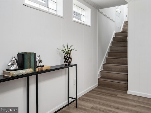 stairway with baseboards and wood finished floors