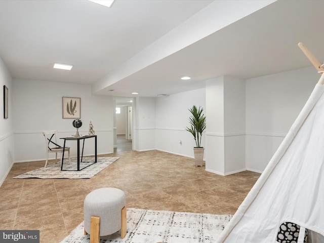 interior space with tile patterned flooring and wainscoting