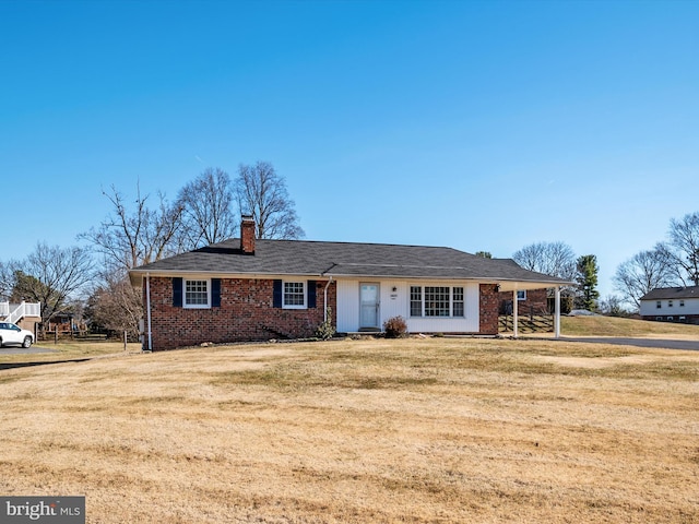 ranch-style home with a front lawn, brick siding, and a chimney