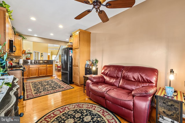 living area with recessed lighting, light wood-style floors, and a ceiling fan