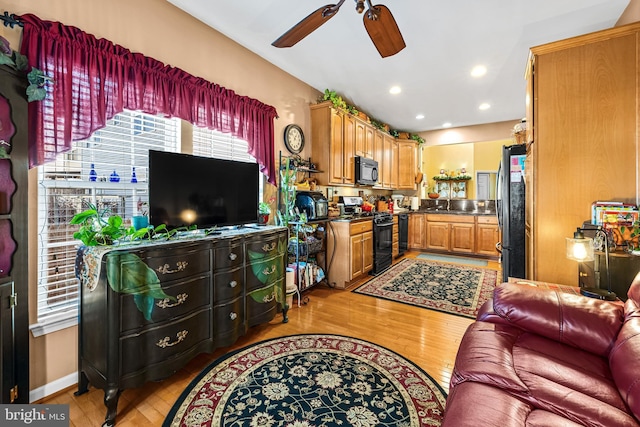 living room with recessed lighting, light wood-type flooring, baseboards, and a ceiling fan