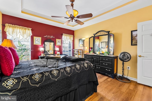 bedroom with baseboards, wood finished floors, and a ceiling fan