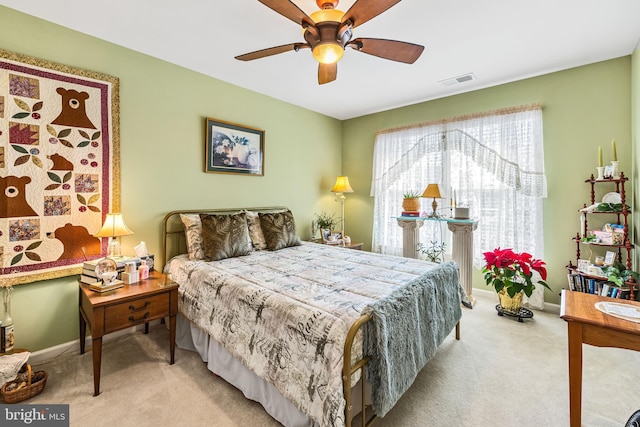 bedroom featuring a ceiling fan, baseboards, visible vents, and carpet floors