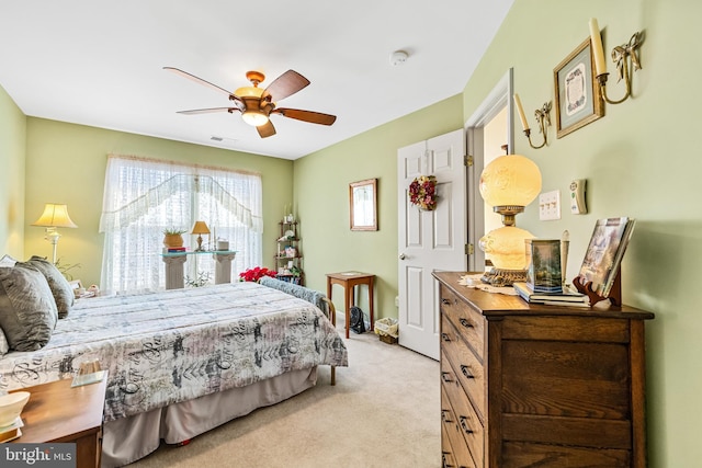 carpeted bedroom featuring visible vents and a ceiling fan