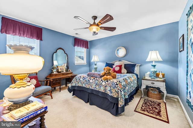 carpeted bedroom featuring visible vents, a ceiling fan, and baseboards