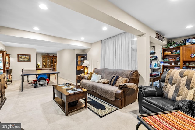 living area with light carpet, recessed lighting, and baseboards